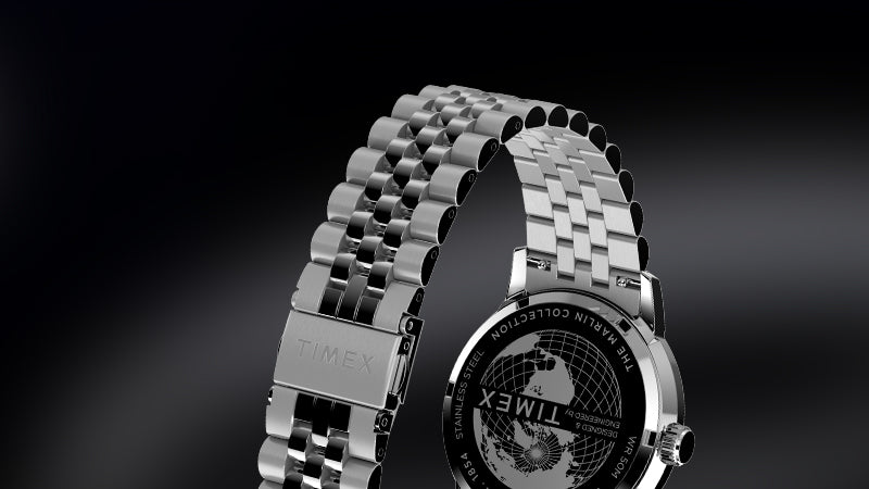 Close-up of the back and stainless steel bracelet of a Timex Marlin Moon Phase watch, showing the engraved case back with globe design and the TIMEX logo on the clasp.