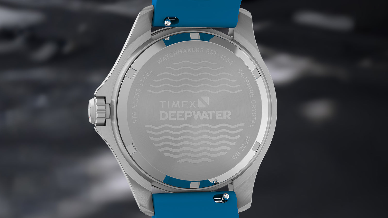 Detailed close-up of the aqua blue silicone strap of the Timex Deepwater Meridian 200 with water droplets.