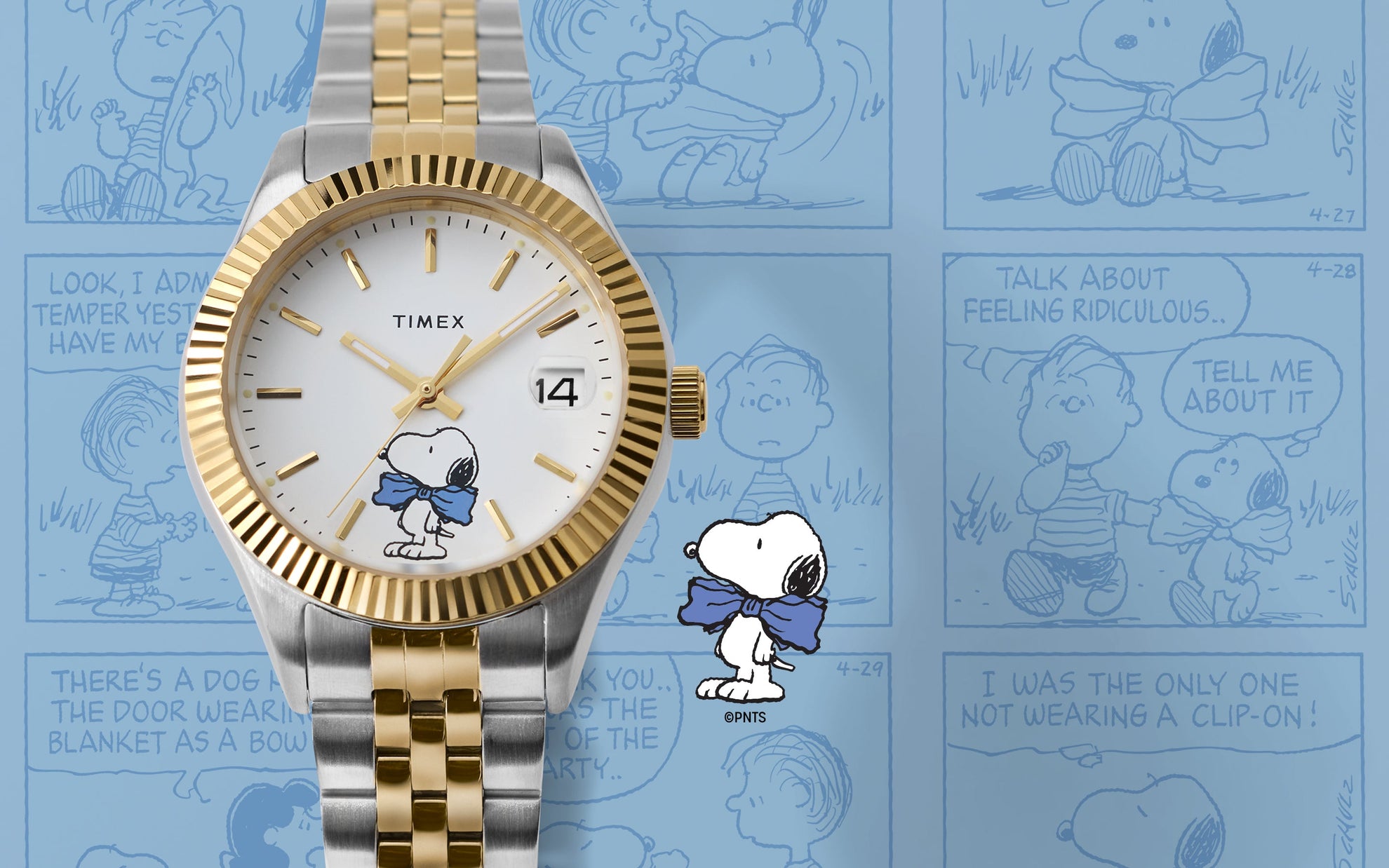 Timex x Peanuts® Timex Legacy watch in silver and gold-tone with white dial and Snoopy in a blue bow tie, displayed against a blue background with Peanuts® comic strip panels.