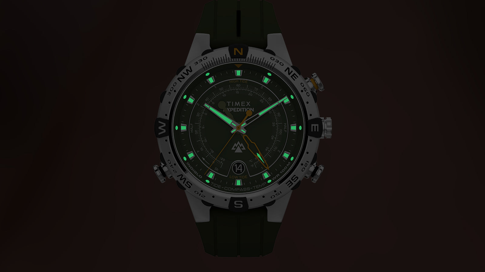 Timex Expedition® Tide-Temp-Compass watch face glowing in the dark with bright green luminescent hour markers and hands.