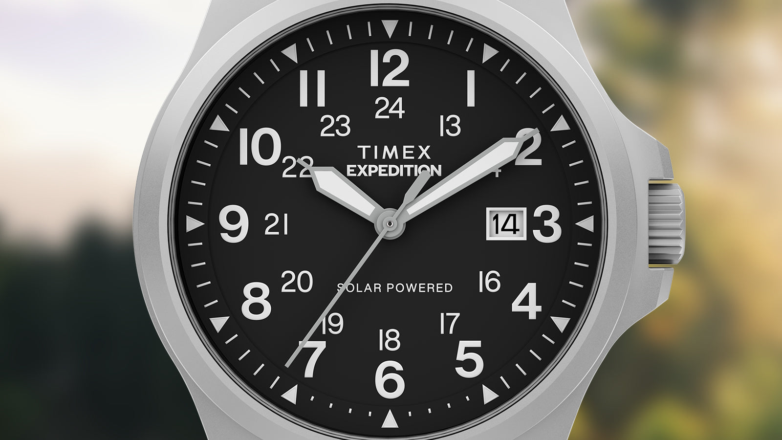 Close-up of the black dial showing bold white numerals, luminous hands, and date window at 3 o’clock, with “Solar Powered” marking.