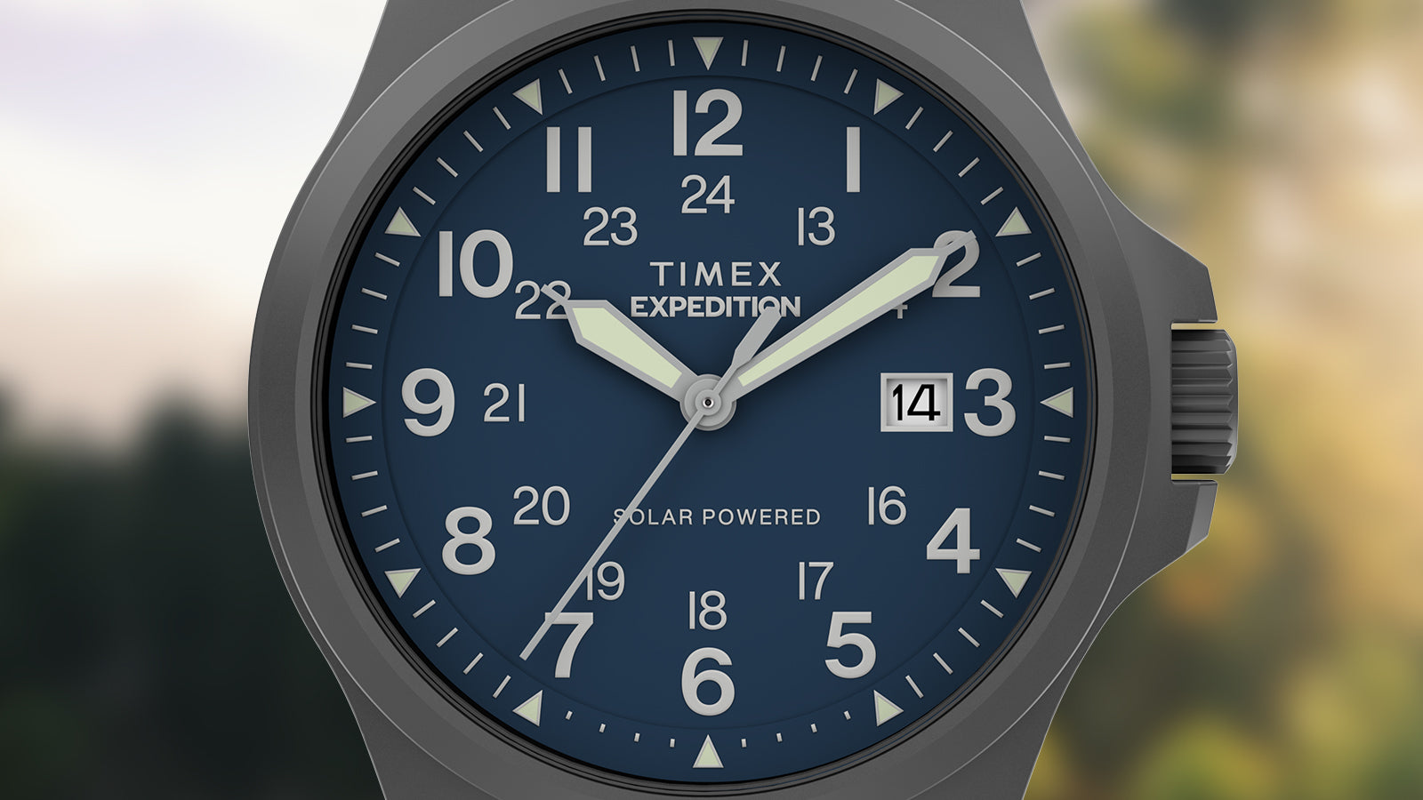 Close-up of the watch face showing bold white Arabic numerals, luminous hands, 24-hour inner track, date window at 3 o’clock, and “Solar Powered” marking.