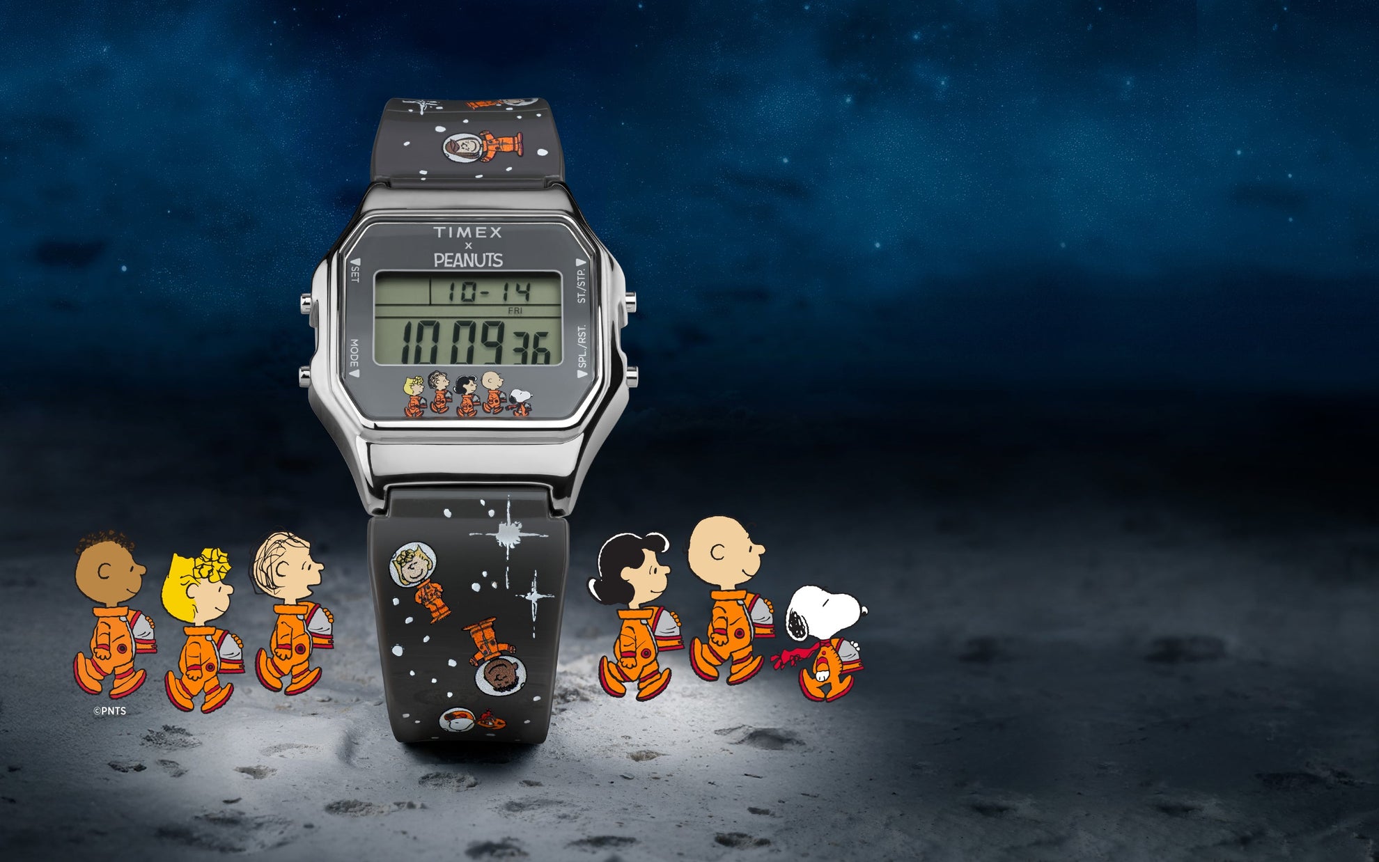 A Timex x Peanuts® T80 digital watch displayed on a lunar surface background with a starry night sky. The stainless steel square case frames a green digital display that shows the time, date, and alarm icons. Along the bottom of the display, Charlie Brown, Snoopy, Lucy, Linus, Franklin, and Woodstock appear in orange space suits. The black resin strap is decorated with white stars and Peanuts space-themed illustrations.