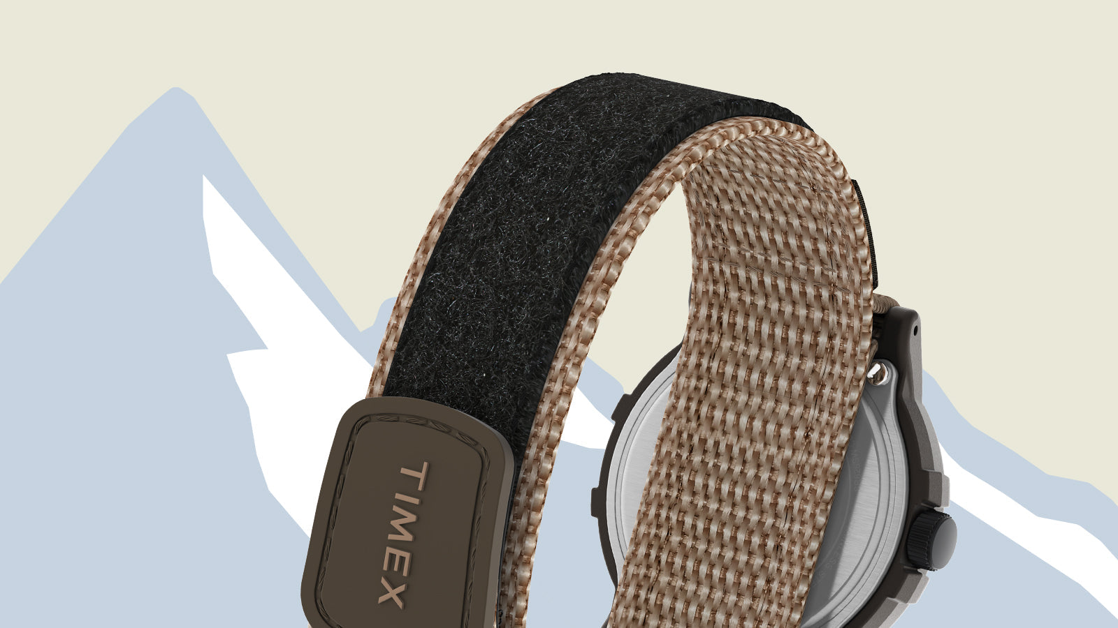 Close-up of the tan and black fabric strap of the Timex x Peanuts® Camper Ski watch, showing woven texture and the Timex logo embossed on the Velcro closure.