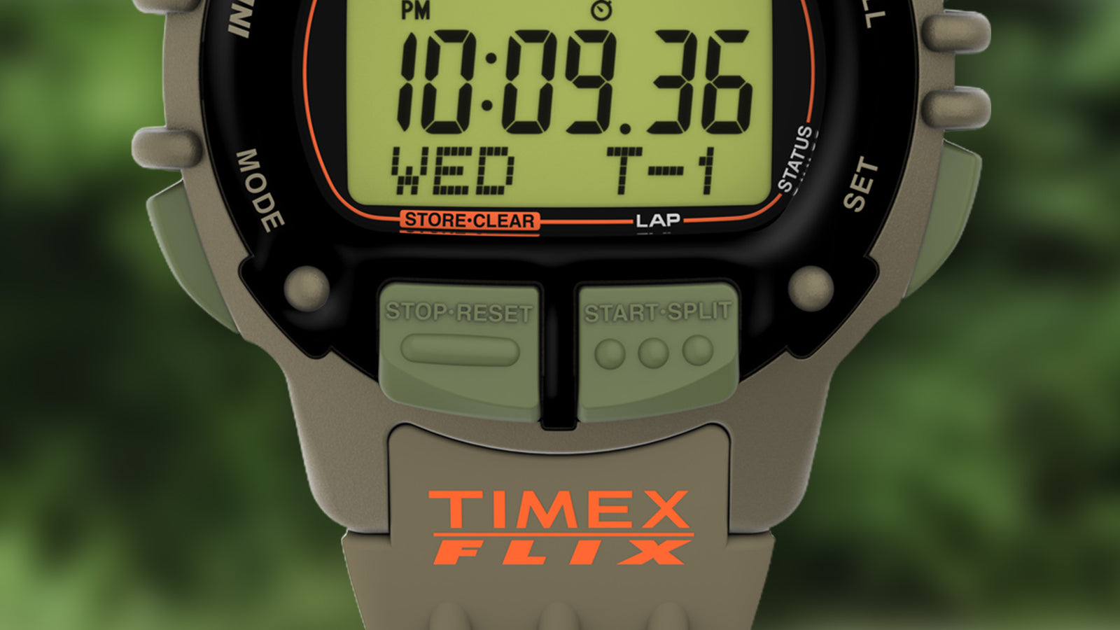 A macro shot of the TIMEX® IRONMAN® Flix x Huckberry’s control buttons, including the Stop/Reset and Start/Split pushers in green and the bold orange TIMEX FLIX logo on the strap.