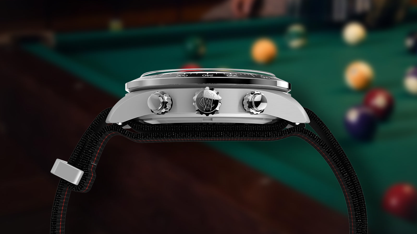 Side profile of the Timex Waterbury Heritage Chronograph watch showing stainless-steel pushers, crown with Waterbury logo, and black fabric strap with red stitching.