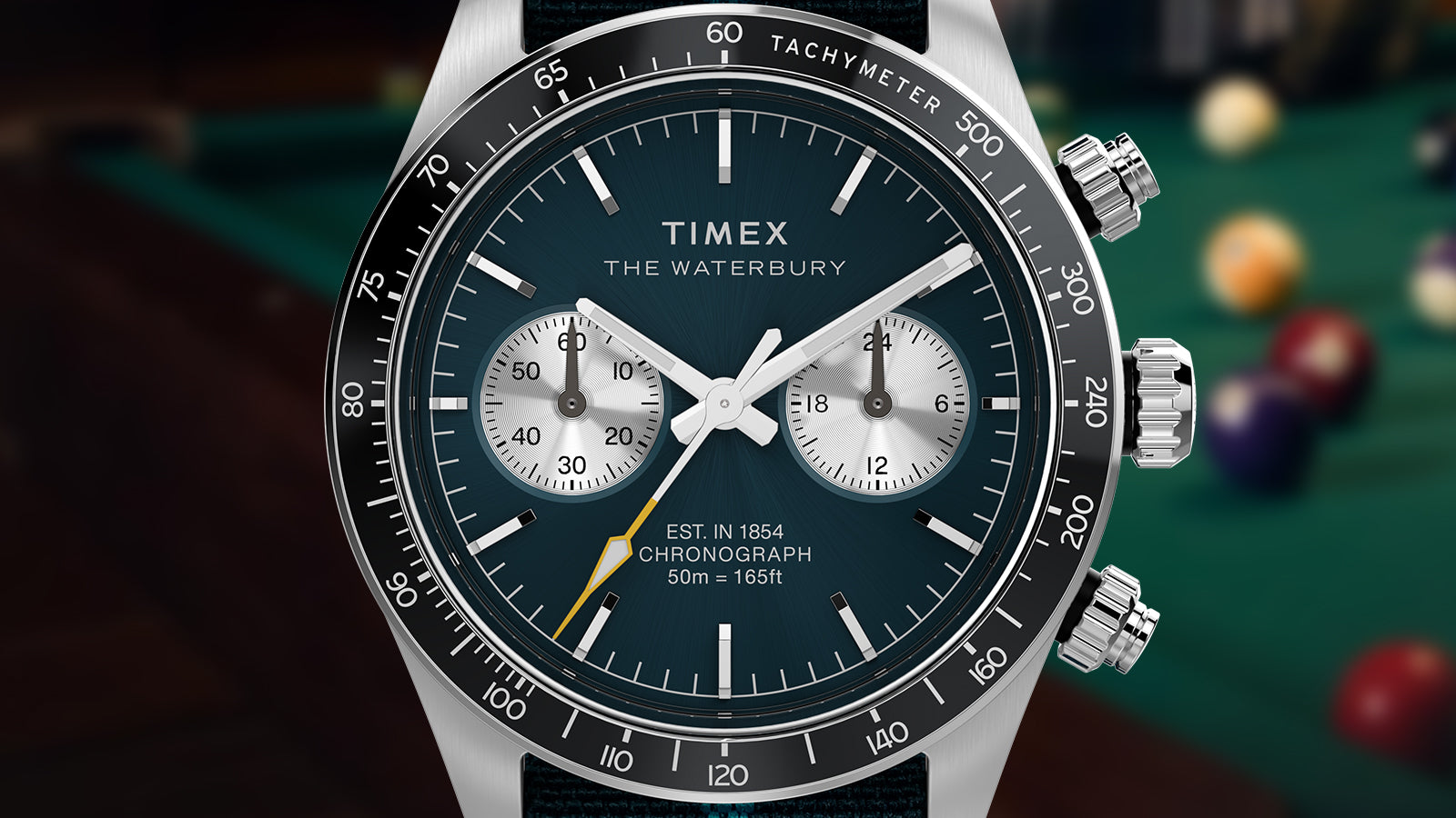 Macro shot of the Timex Waterbury Heritage Chronograph dial showing tachymeter bezel, dual subdials, and detailed chronograph markings.