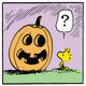 Woodstock from Peanuts looks puzzled at a smiling jack-o’-lantern with a question mark above his head.