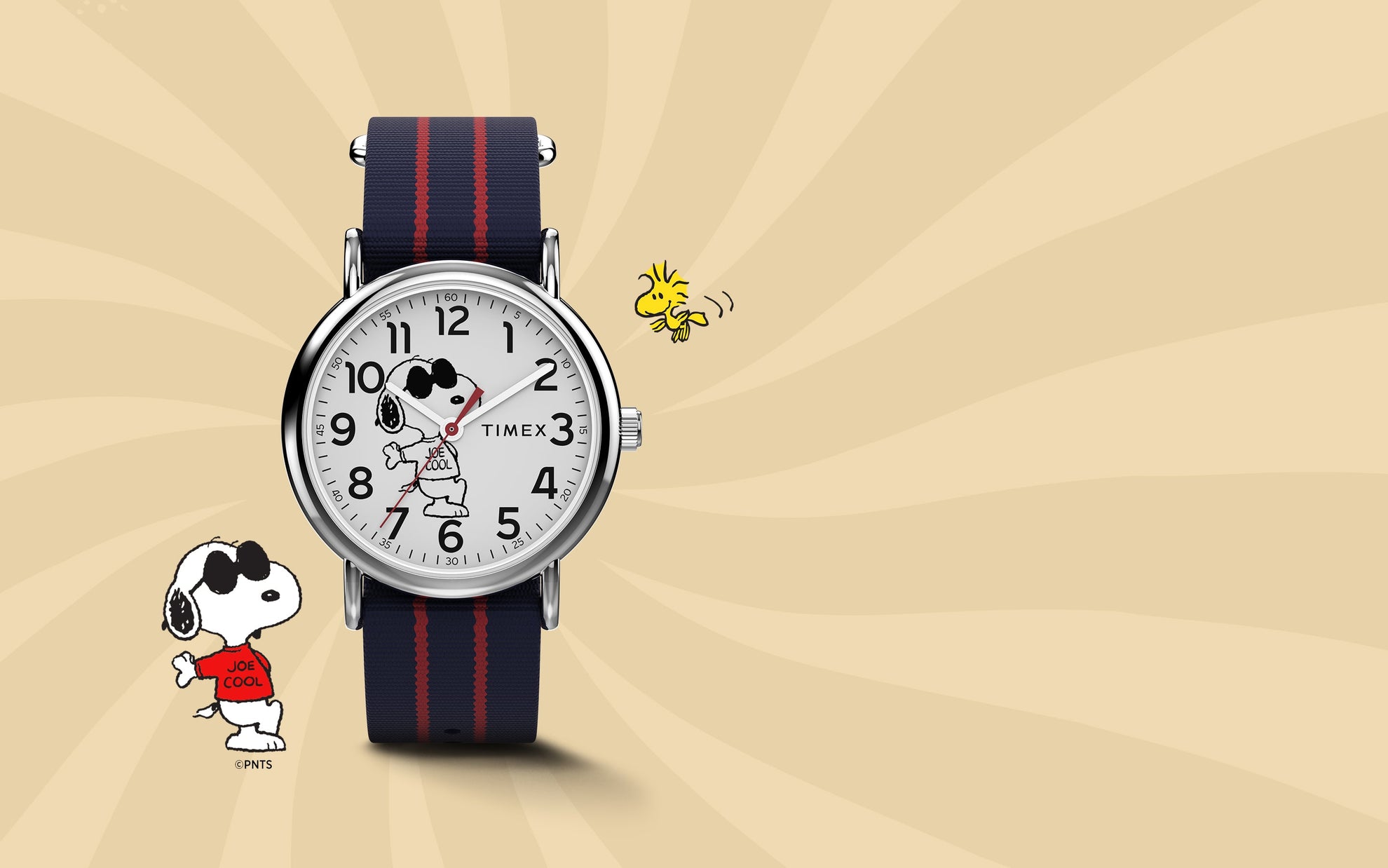 Timex x Peanuts® Weekender watch featuring Snoopy as “Joe Cool” on the dial, paired with a navy and red-striped fabric strap. Displayed on a warm beige background with Snoopy and Woodstock illustrations for a playful, nostalgic look.