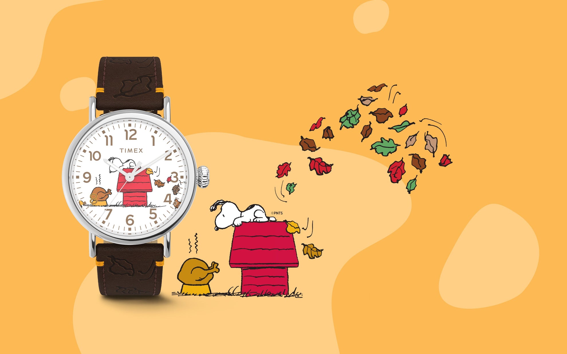 Timex x Peanuts® Standard Thanksgiving Edition watch displayed next to a Snoopy and Woodstock illustration surrounded by colorful falling leaves, celebrating a cozy fall theme.