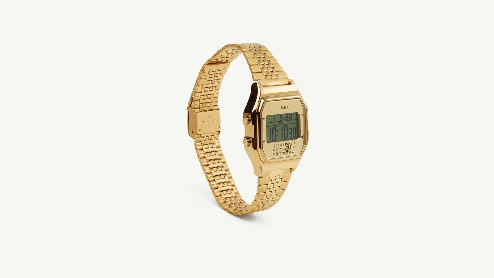 Side-angled view of the Timex x MM6 T80 digital gold-tone watch, highlighting the slim retro case and integrated bracelet design.