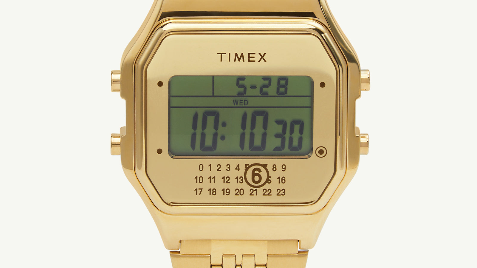 Front-facing macro shot of the Timex x MM6 T80 display showing the date (5-28), day (Wednesday), and time (10:10:30), with MM6’s signature circled 6 design below.