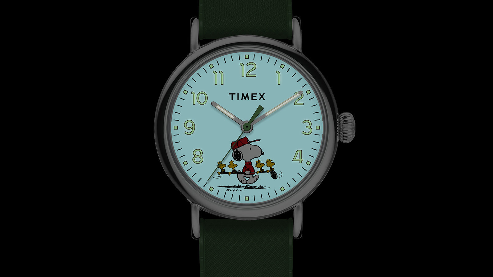 The Timex x Peanuts® Standard watch dial illuminated with Timex’s INDIGLO® light-up feature. Snoopy and Woodstock appear on the glowing dial, highlighting the watch’s whimsical golf-themed design.