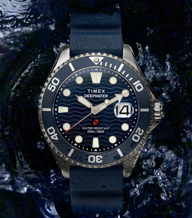 Timex Deepwater Meridian 200 dive watch with blue strap and wavy blue dial surrounded by splashing water, emphasizing its rugged 200-meter water resistance.