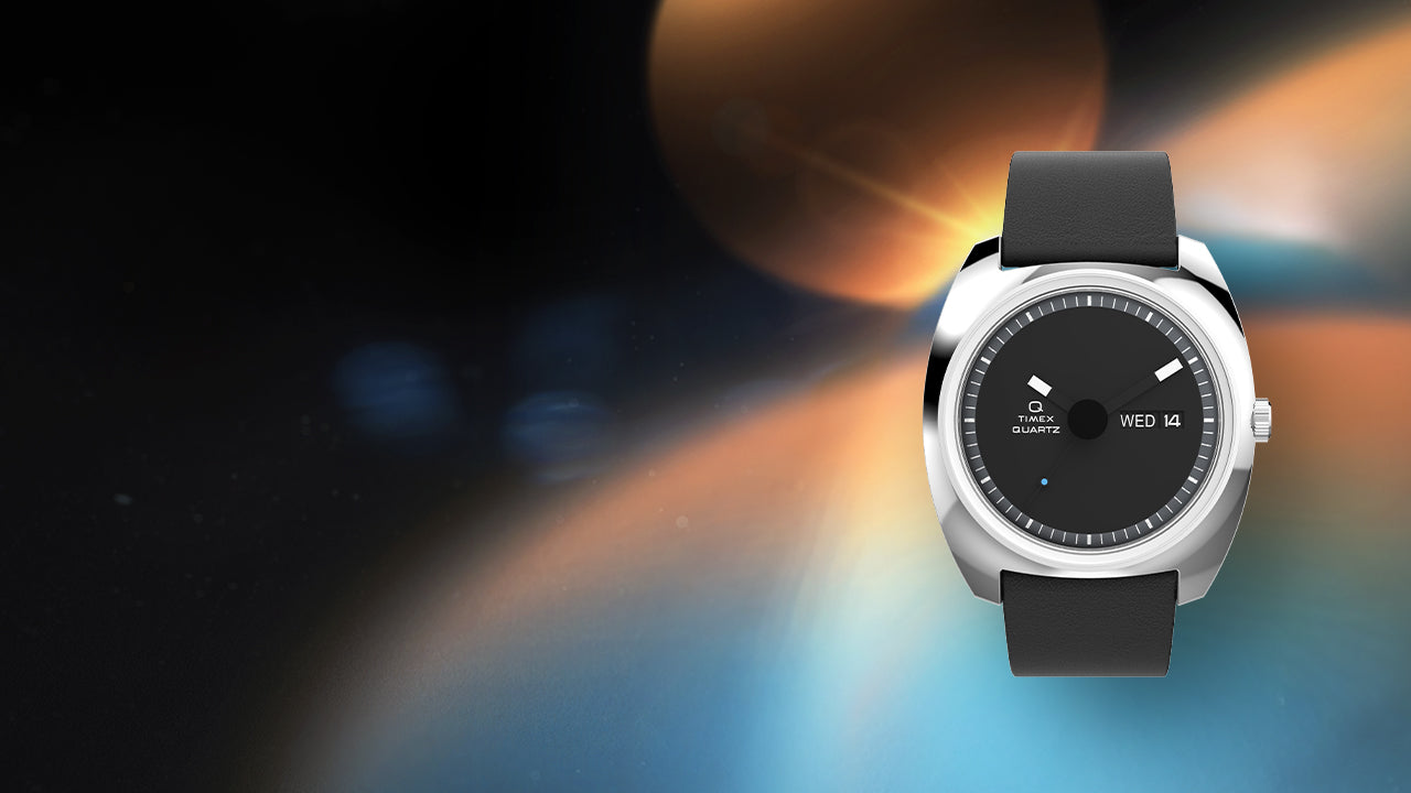 Full product image of the Q Timex® 1975 Enigma watch centered against a vibrant abstract space background, highlighting its futuristic 1970s-inspired design.