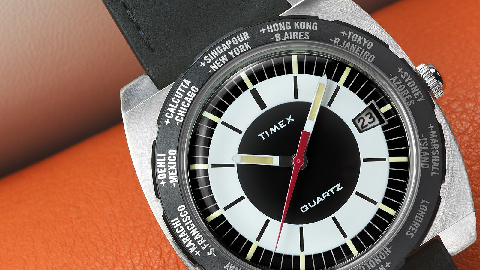 Detailed macro shot of the Timex World Time Reissue dial showing the upper half of the watch face, including the city bezel markings for Singapore, New York, Hong Kong, and Tokyo.