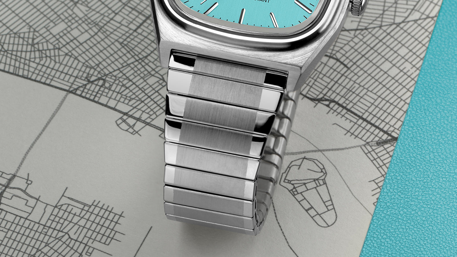 Detailed macro shot of the Timex® Automatic 1983 E Line Reissue bracelet showing alternating brushed and polished stainless-steel links.