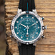 Front view of the Timex Expedition Tide-Temp-Compass highlighting the teal dial with wave detailing, white luminous hands, tide and temperature indicators, compass bezel, and date display at 6 o’clock.