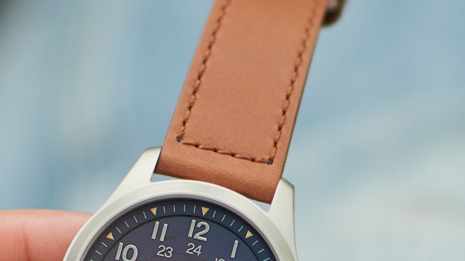 Close-up of the brown leather strap of the Timex Expedition Field Post Solar watch, highlighting the stitching detail and premium finish.