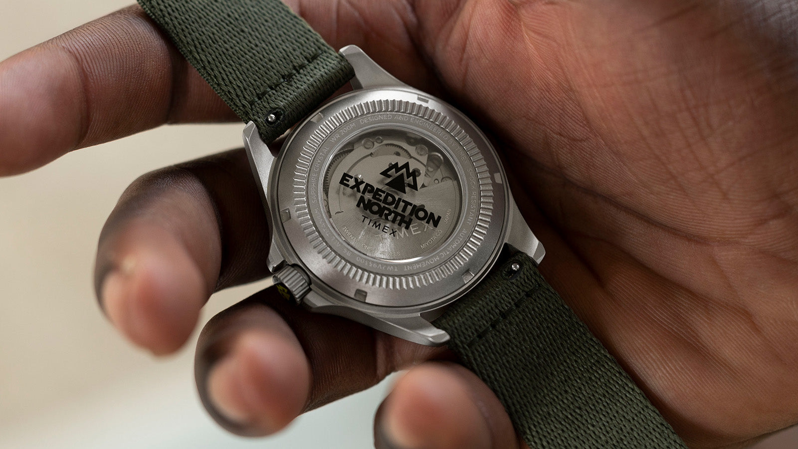 Close-up of the transparent caseback of the Timex Expedition North Titanium Automatic watch, revealing its automatic movement with “Expedition North” engraving on the rotor.