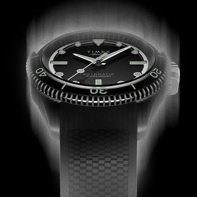 Front view of the Timex Atelier automatic dive watch with black dial, luminous indices, and black textured rubber strap, designed for mobile display.