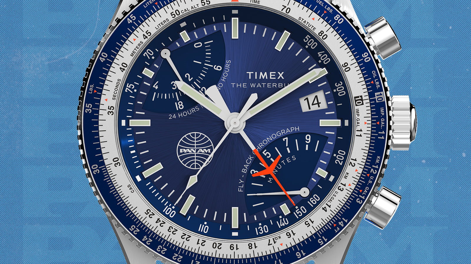 Macro shot of the Timex x Pan Am® Fly-Back Chronograph’s blue dial with luminous hands, bold indices, and red chronograph seconds hand. The bezel’s flight-scale markings and the Pan Am globe logo emphasize the aviation-inspired design.