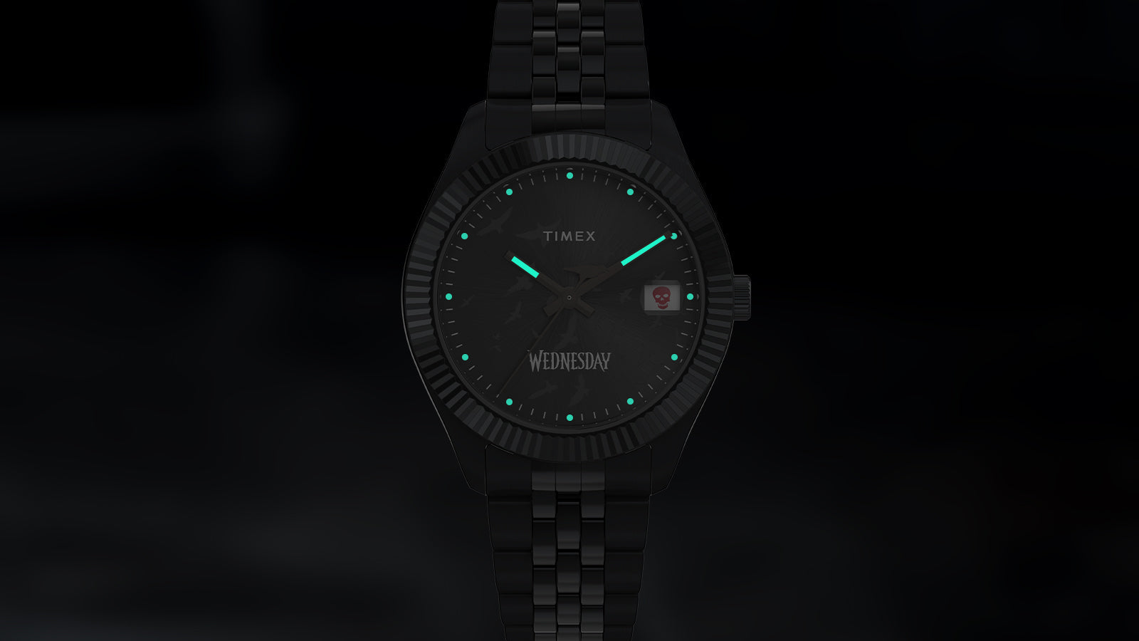 Timex x Wednesday Timex Legacy watch glowing in the dark with luminescent green hands and markers. The moody black dial and subtle lighting create a haunting yet sophisticated nighttime look.