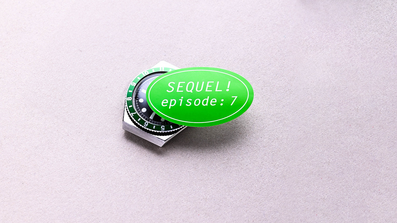 Timex x seconde/seconde/ Q Timex watch topped with a green oval sticker reading “SEQUEL! episode: 7” placed on a neutral background, emphasizing the playful narrative behind the limited-edition design.