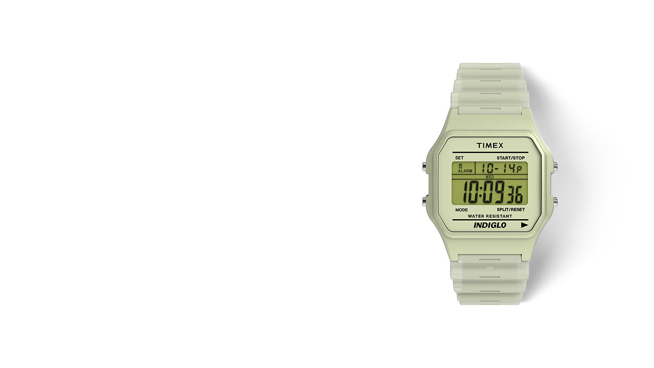 Front view of the TIMEX® T80 digital watch with a pale cream case and matching resin strap, displaying the time, date, and day on its digital screen.