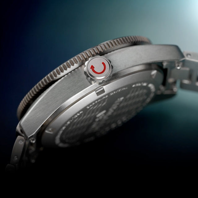 Side profile of the Timex Deepwater Reef 200 Titanium showing the brushed case, screw-down crown with red accent, and sapphire caseback.