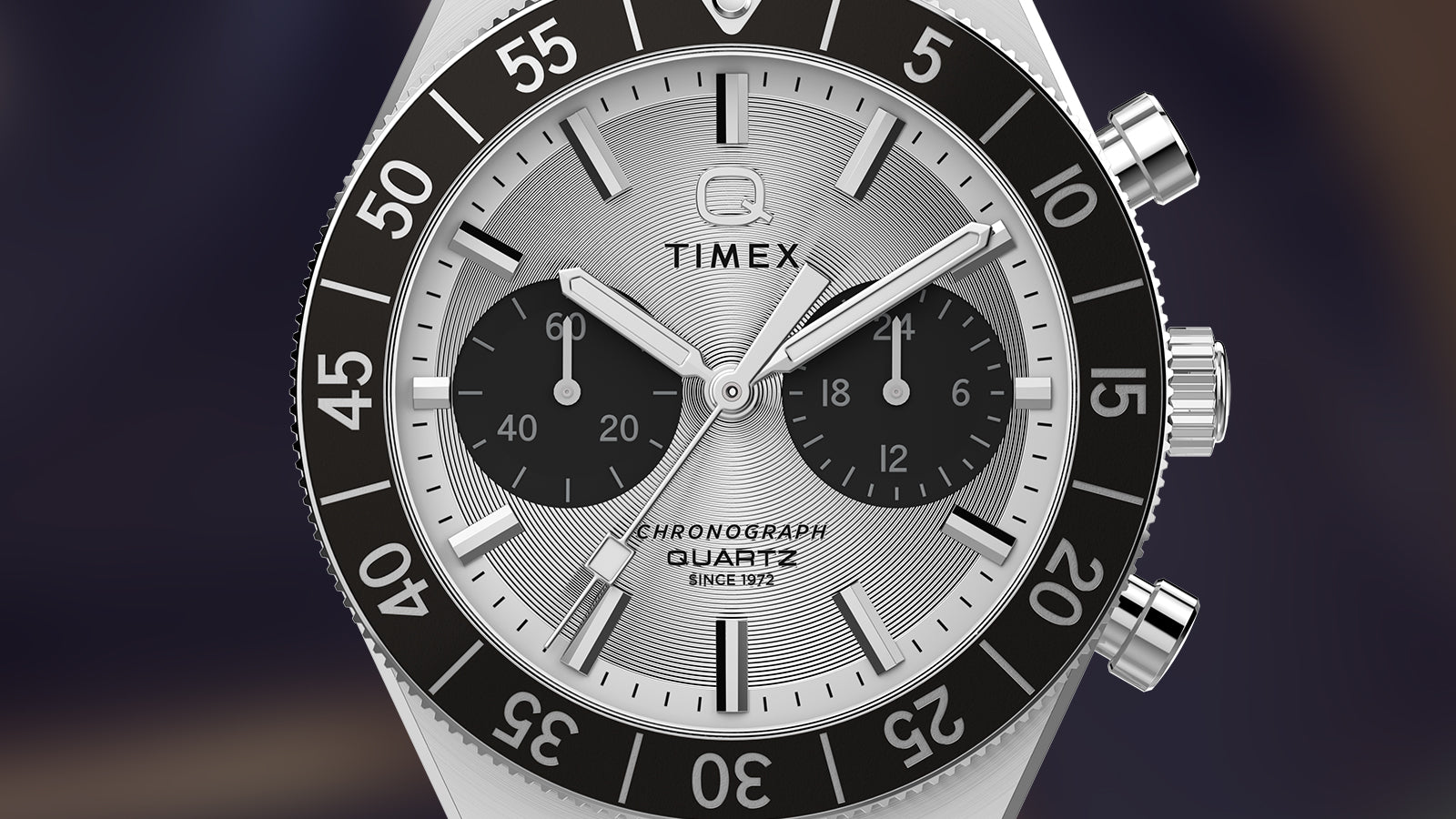 Close-up of the Q Timex Continental Chronograph dial with silver sunray finish, black subdials, and chronograph quartz movement.
