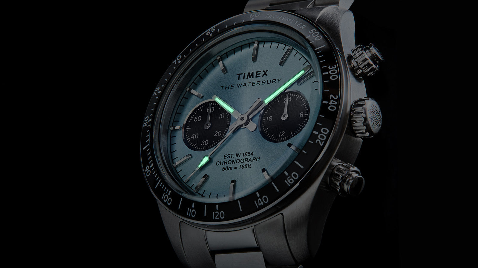 Close-up of Timex Waterbury Heritage Chronograph on wrist, highlighting the light blue dial and chronograph subdials.