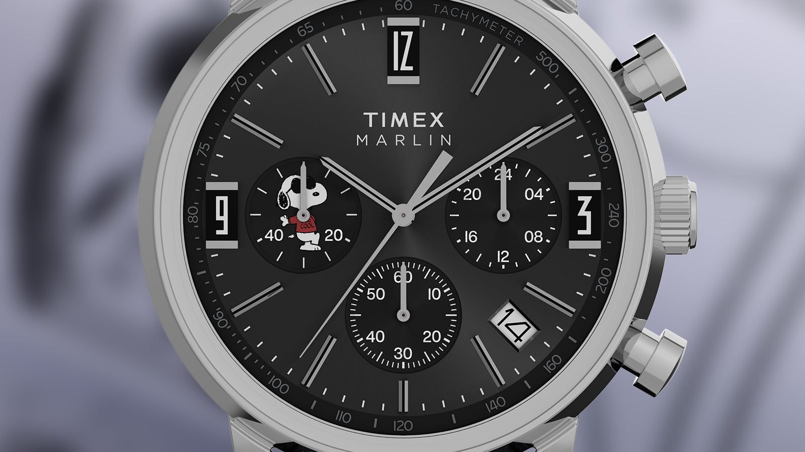 Close-up of the Peanuts® x Timex Marlin® Chronograph Joe Cool black dial, highlighting silver hour markers, chronograph subdials, tachymeter scale, date window, and Snoopy Joe Cool illustration.