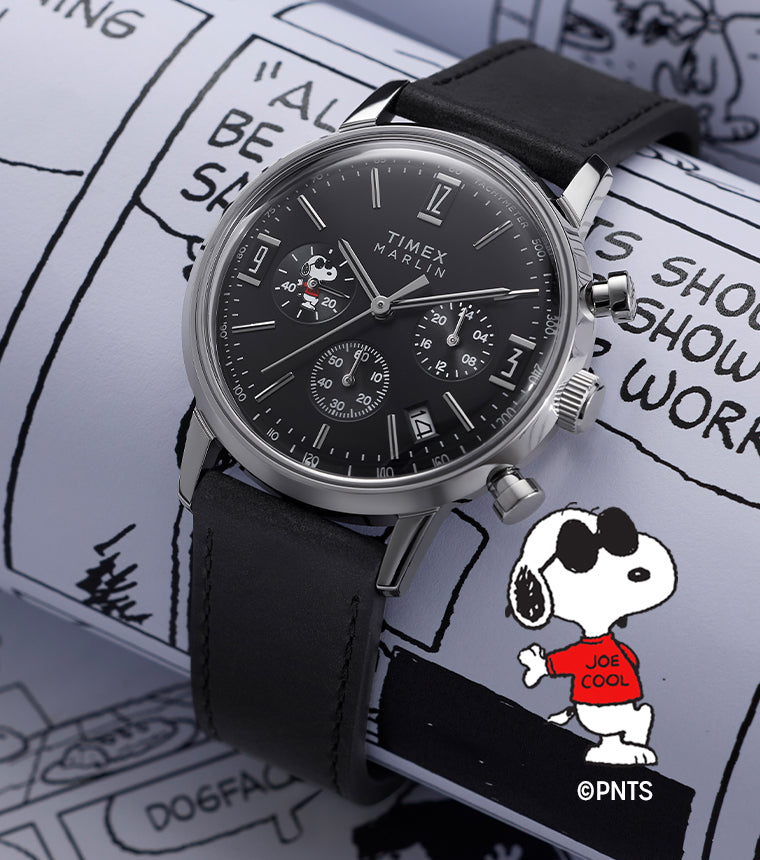 Peanuts® x Timex Marlin® Chronograph with black dial and black leather strap, featuring Snoopy in the subdial, displayed on a Peanuts comic strip background with Joe Cool illustrated in a red shirt.