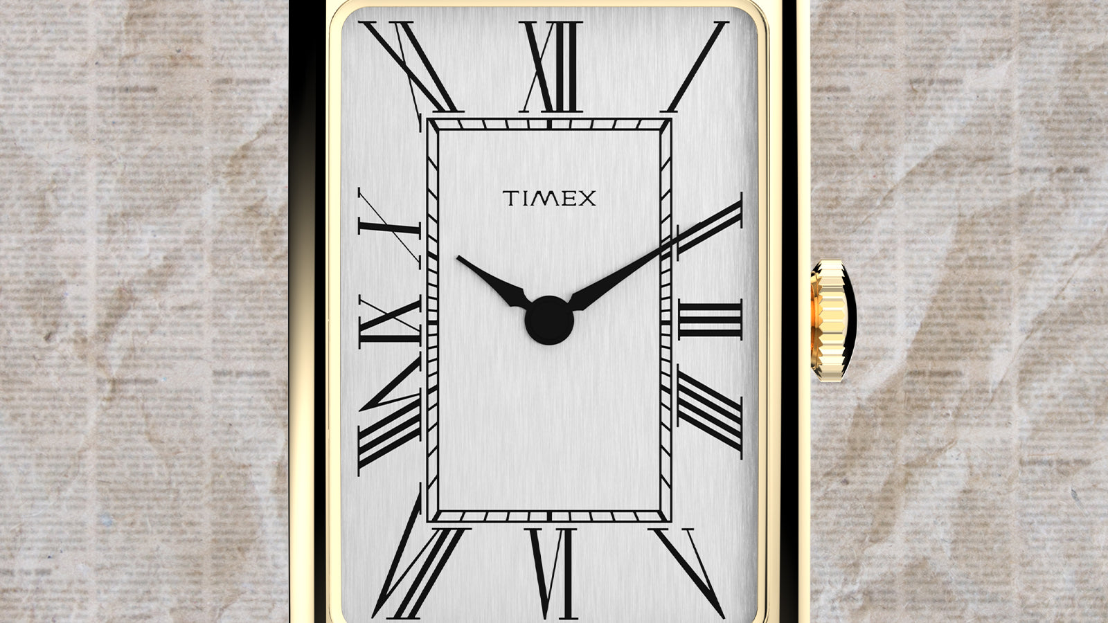 Close-up of the Timex 1976 Lexington Reissue featuring a gold-tone rectangular case, brushed silver dial, black Roman numerals.