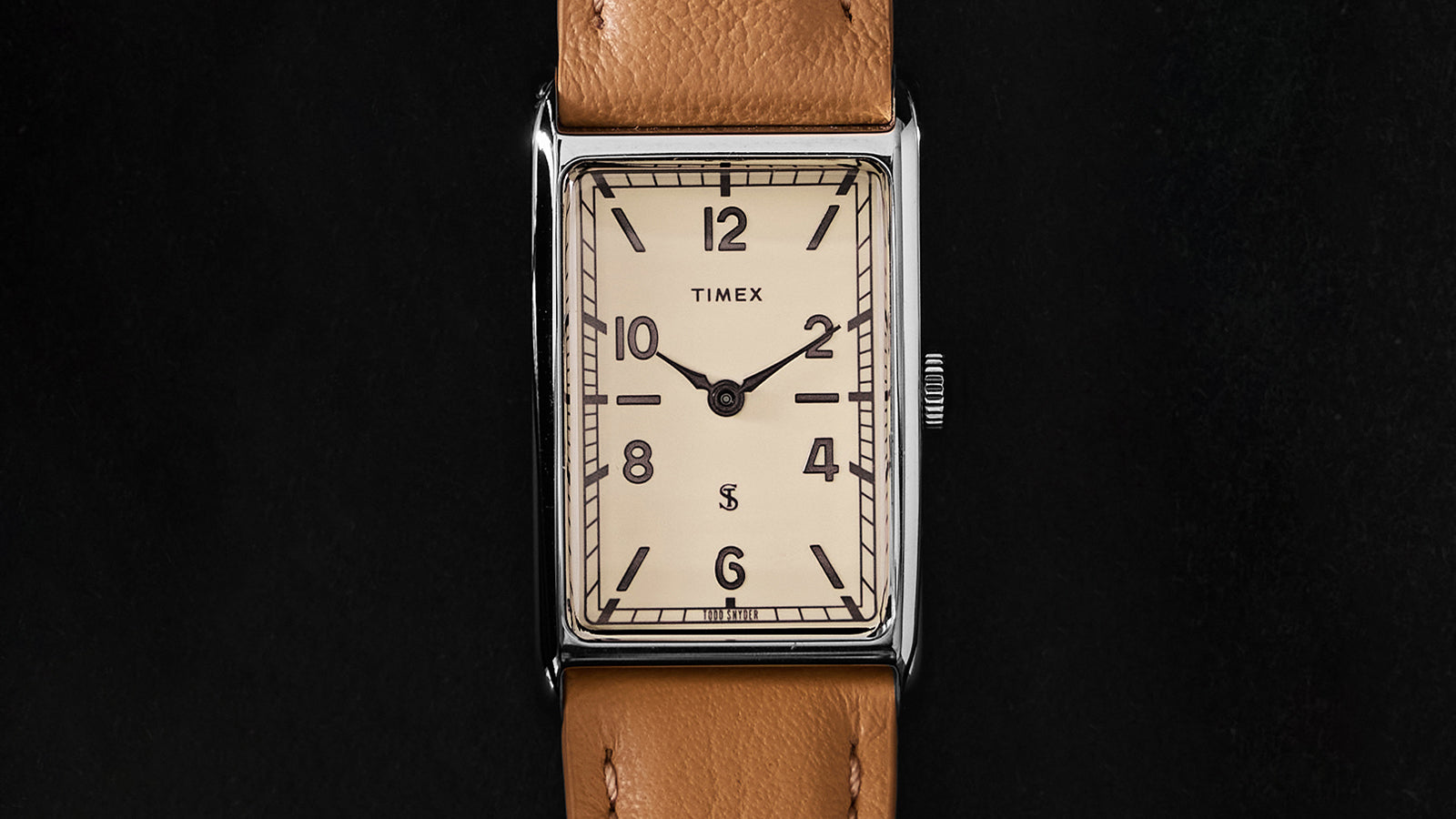 Close-up of the Timex x Todd Snyder 1976 Lexington watch face featuring a cream dial, Arabic numerals, and rectangular case.