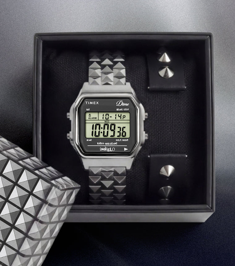 Timex x Dime digital watch set in box with interchangeable studded strap and stainless steel bracelet.