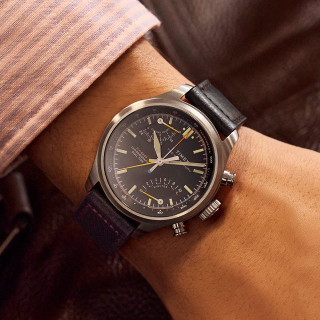 Timex Waterbury Ace Fly-Back Chronograph worn on wrist with black leather strap and brushed stainless steel case