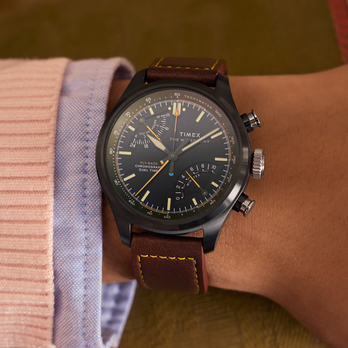 Timex Waterbury Ace Fly-Back Chronograph worn on wrist with brown leather strap and dark case