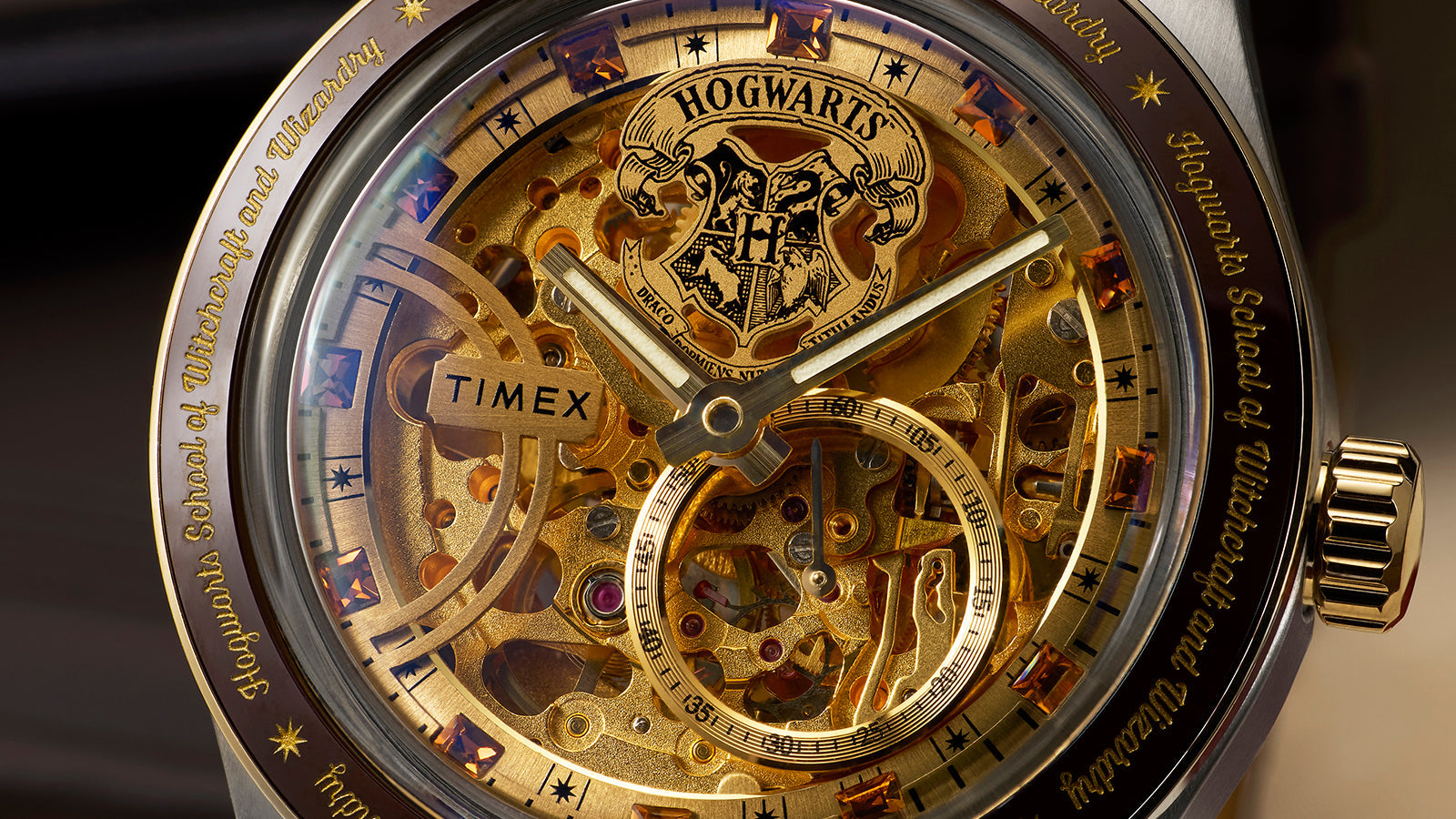 Close-up of Harry Potter x Timex Waterbury Skeleton Automatic dial with visible gold-tone movement and Hogwarts crest at 12 o’clock.