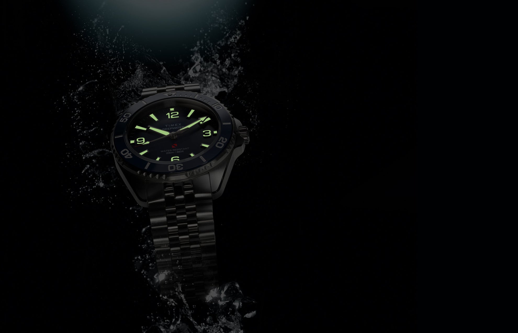 Timex Deepwater Arctic blue dial dive watch with glowing lume markers emerging through water