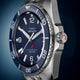 Angled close-up of Timex Deepwater Arctic watch with blue dial, stainless steel case, and dive bezel