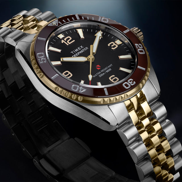 Close-up of Timex Deepwater Arctic two-tone watch with burgundy bezel and stainless steel case