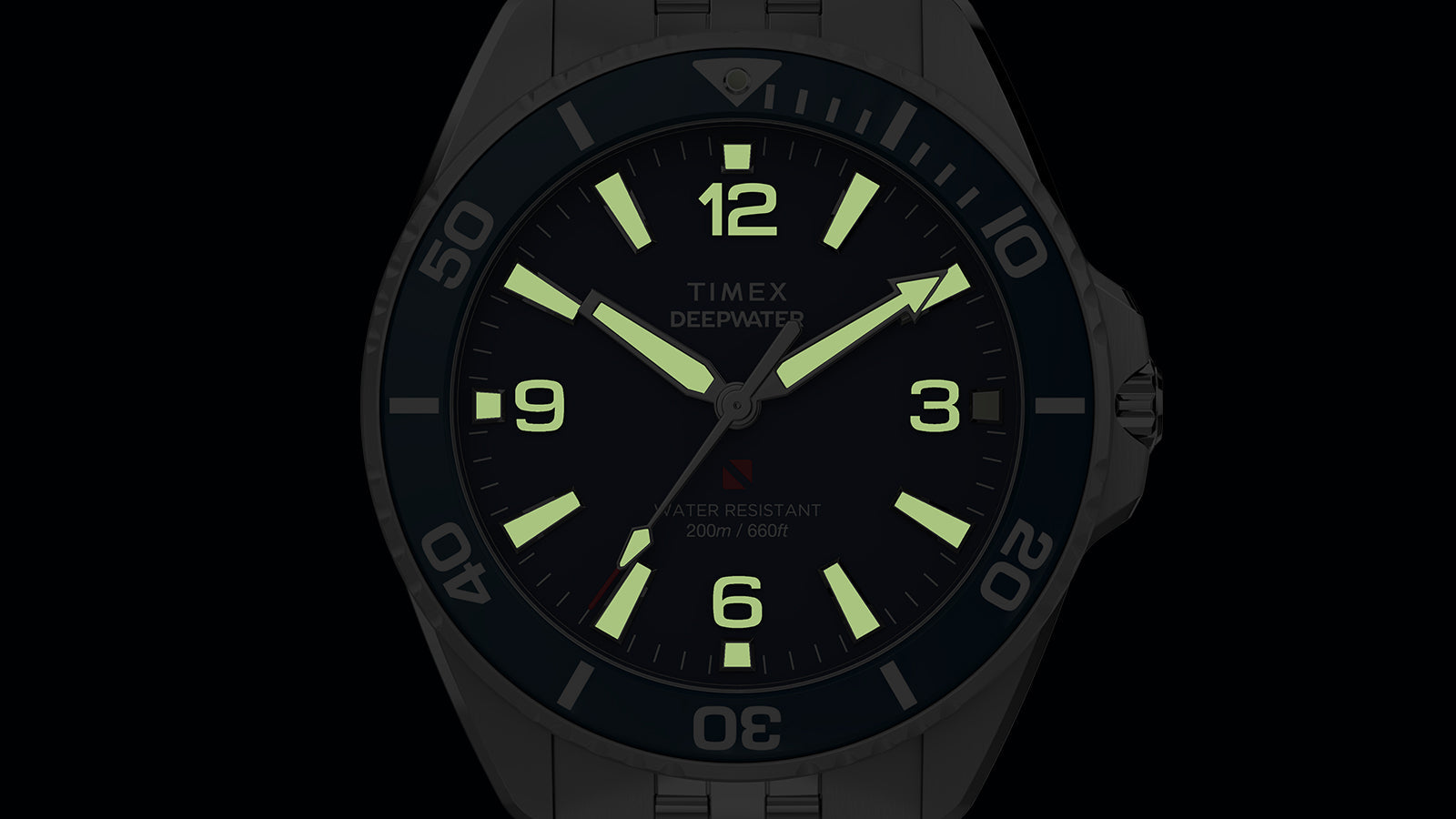 Timex Deepwater Arctic blue dial watch with fully illuminated lume markers and hands in darkness