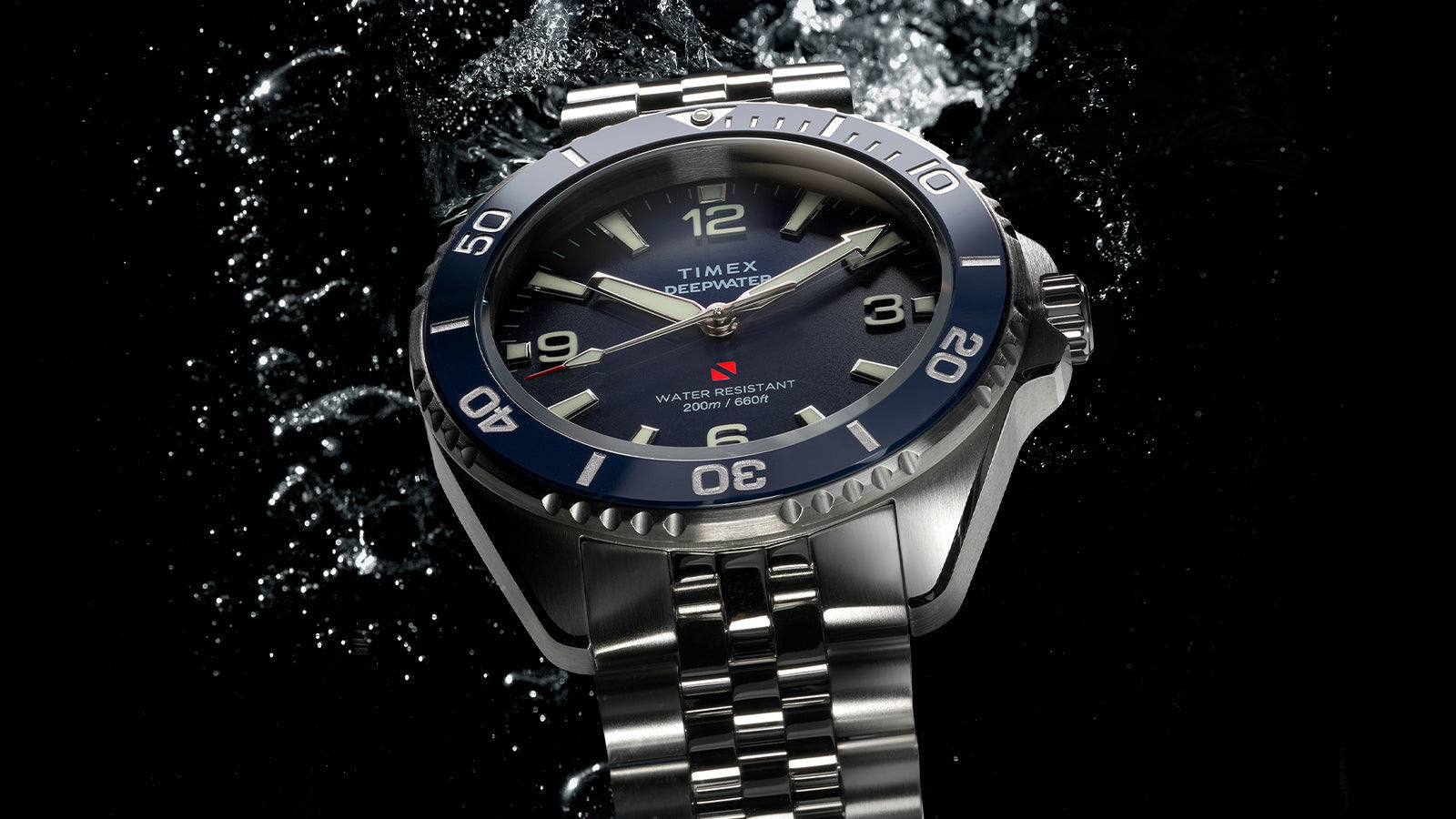 Timex Deepwater Arctic blue dial dive watch with stainless steel bracelet and water splash background