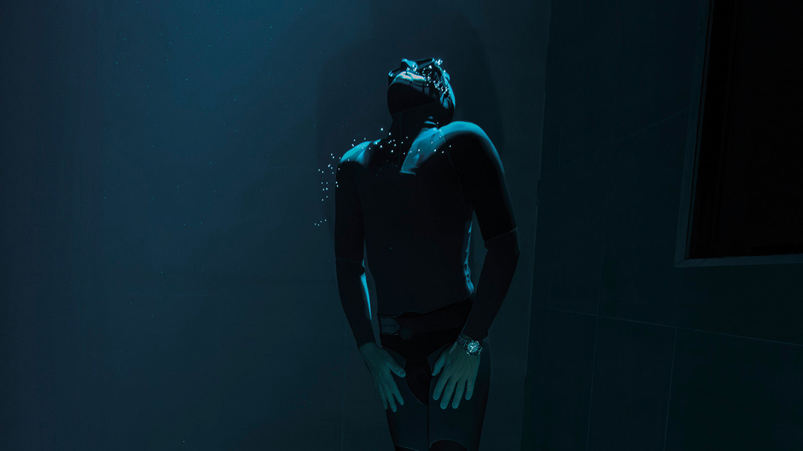 Diver underwater wearing Timex Deepwater Arctic watch in deep blue environment