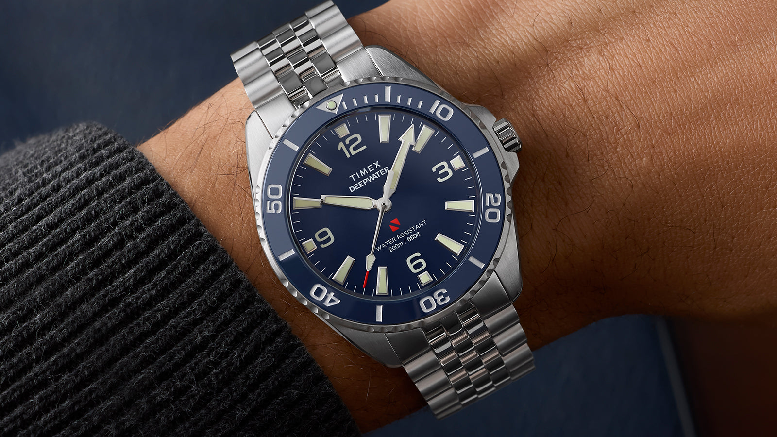 Timex Deepwater Arctic blue dial dive watch on wrist showing stainless steel bracelet