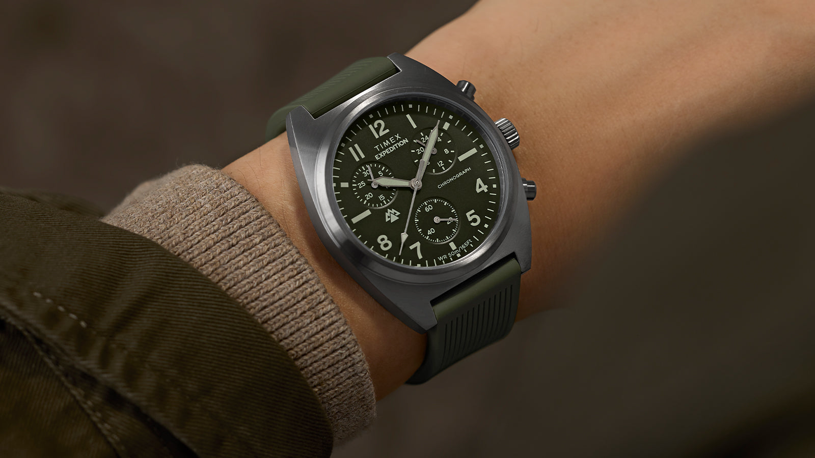 Timex Expedition Capstone Chronograph worn on wrist with stainless steel case and green strap
