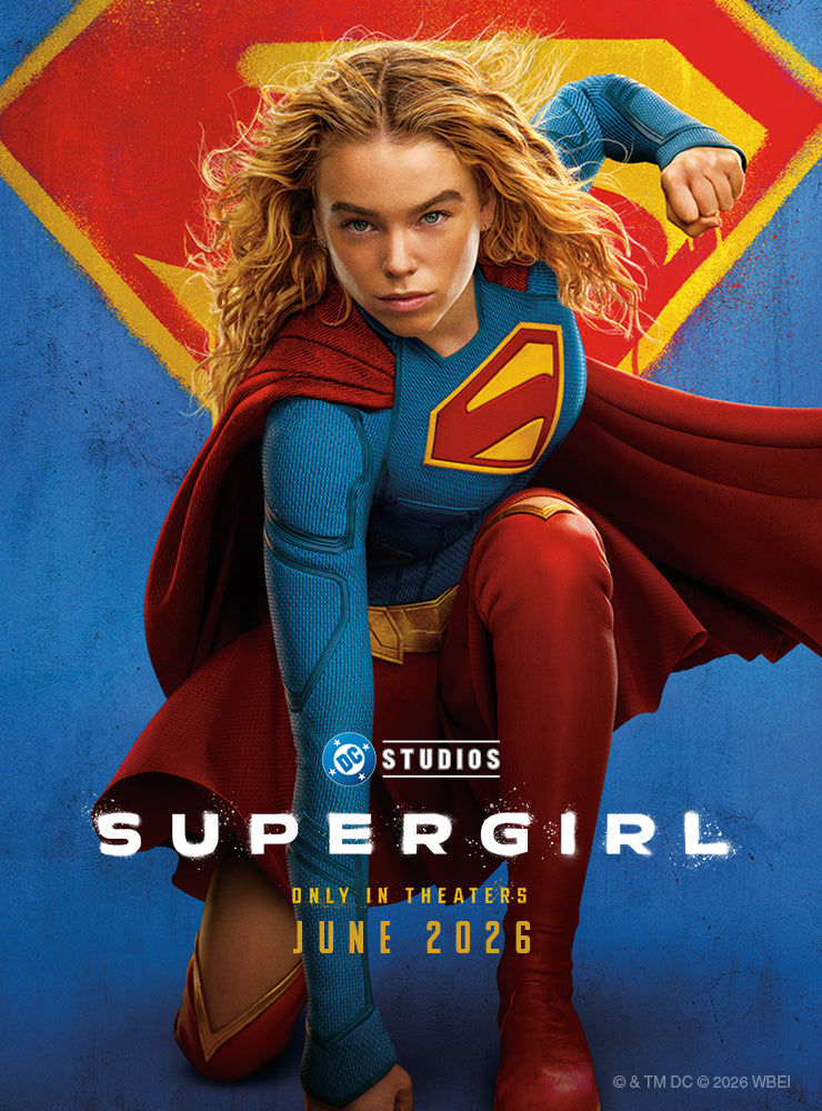 Supergirl promotional banner featuring the superhero in her iconic blue-and-red costume flying forward against a large Superman shield logo, with DC Studios Supergirl movie branding and June 2026 theatrical release information.