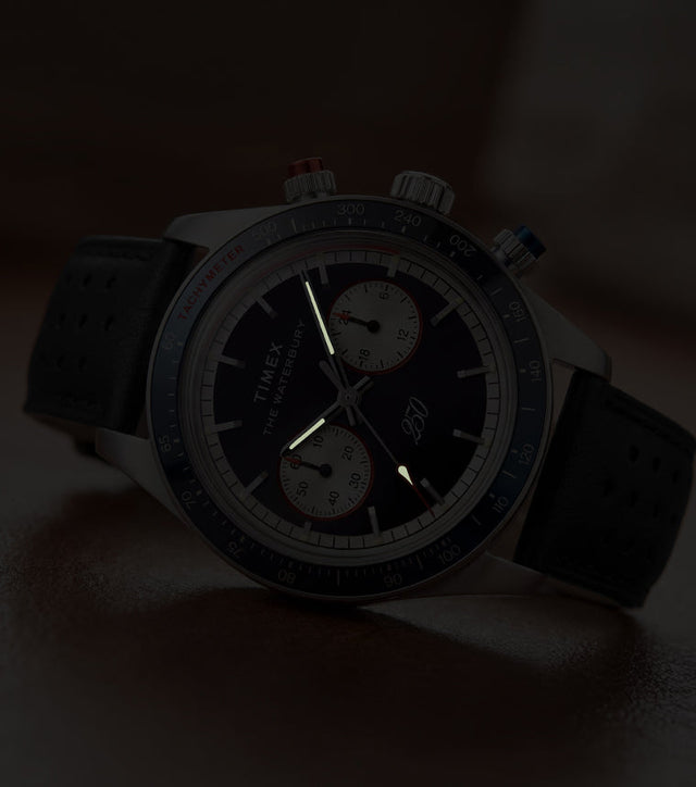 Waterbury Heritage America 250 Chronograph watch showcasing luminous hands and markers in low-light conditions.